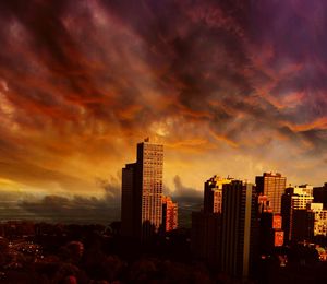 Cityscape against cloudy sky