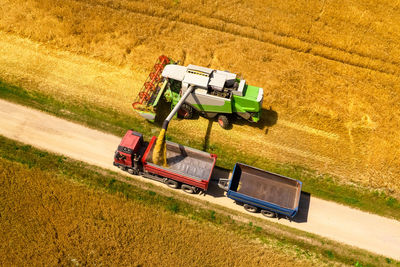 Aerial view of a combine harvester at work during harvest time. agricultural background.