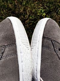 Close-up of shoes on footpath