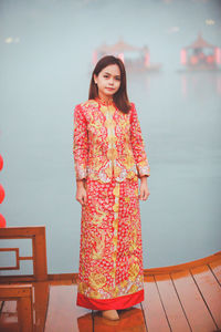 Asian woman wearing cheongsam traditional red dress on chinese new year travel.