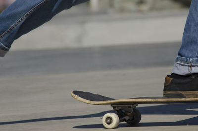 Low section of man skateboarding outdoors