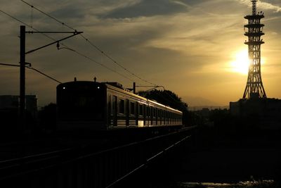 Railroad tracks against cloudy sky