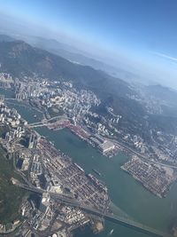 High angle view of buildings by sea against sky