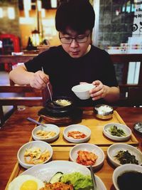 Midsection of man having food in restaurant