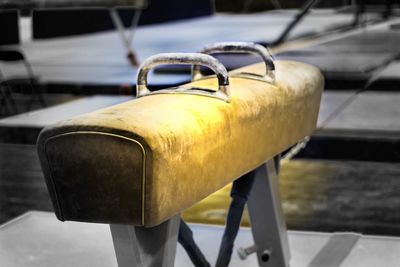 Close-up of yellow camera on railing