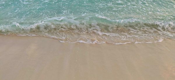 High angle view of waves rushing towards shore