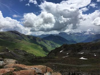 Scenic view of mountains against cloudy sky