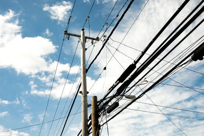 Low angle view of electricity pylon against sky