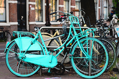 Bicycles on street against buildings in city