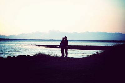 Silhouette of man standing on beach