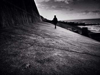 Full length of woman standing by railing