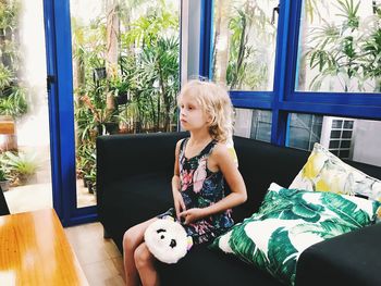 Girl sitting on sofa at home