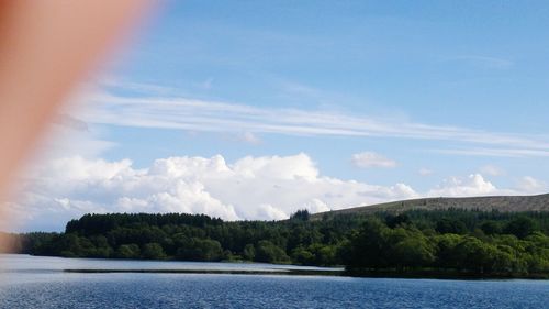 Scenic view of lake against cloudy sky