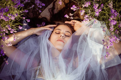 A beautiful young girl against the sunset and a beautiful sky in a lavender field. 