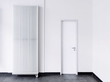 Radiator by closed door in room