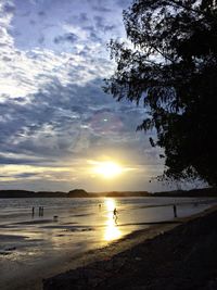 Scenic view of beach against sky during sunset