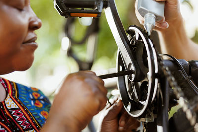 Close-up of man holding bicycle