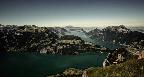 Scenic view of river and mountains against clear sky