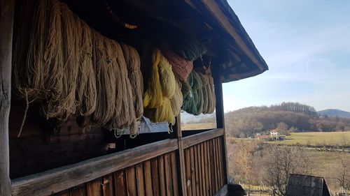 Clothes drying on railing by building against sky