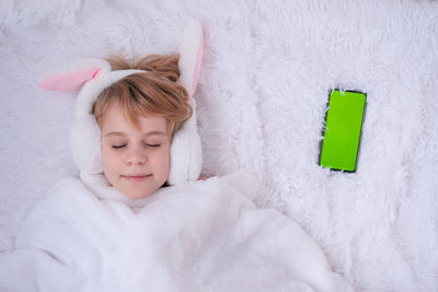 Portrait of cute baby boy sleeping on bed