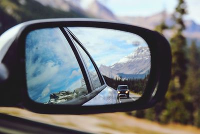 Reflection of cars on side-view mirror