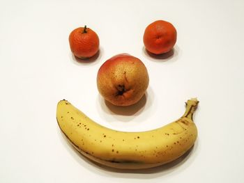 Close-up of fruits over white background