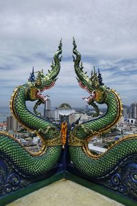 Sculpture of statues on building against sky