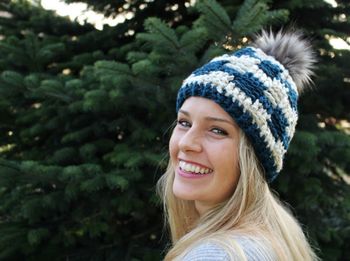 Close-up portrait of smiling woman wearing knit hat
