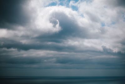 Scenic view of sea against storm clouds