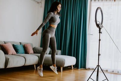 Woman sitting on hardwood floor at home