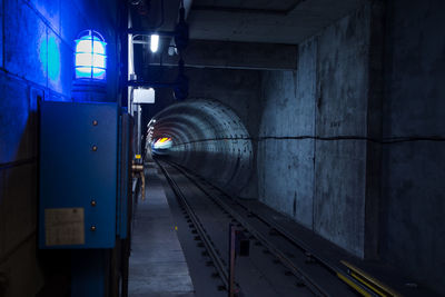 Train in illuminated tunnel
