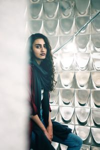 Portrait of young woman standing with umbrella