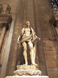 Low angle view of statue against temple