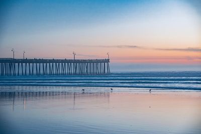 Scenic view of beach against sky during sunset