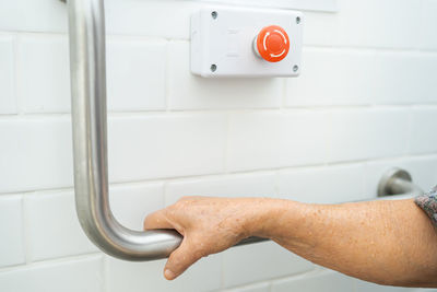 Close-up of man using mobile phone at home
