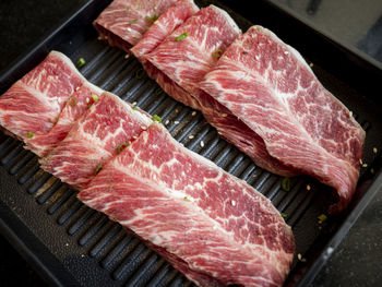 High angle view of meat on barbecue grill