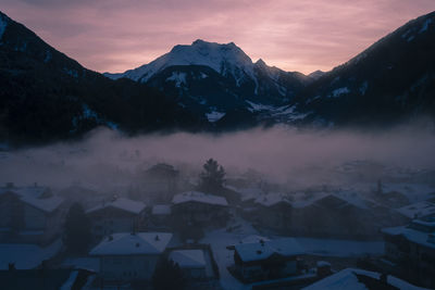 Scenic view of snowcapped mountains against sky during sunset