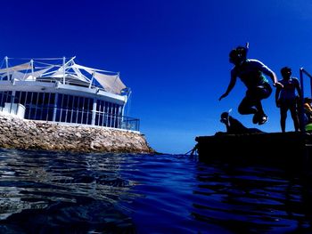 Low angle view of man diving into sea