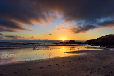 Scenic view of beach against sky during sunset