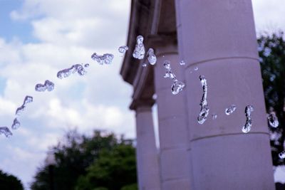 Close-up of water drops on glass against blurred background