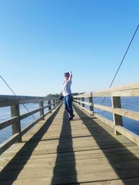 Full length of woman standing against clear sky