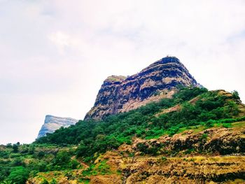 Low angle view of rock formation against sky