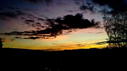 Scenic view of silhouette landscape against sky at sunset