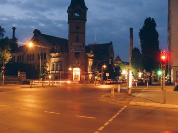 Illuminated city street at night