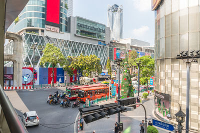 Cars on city street by buildings