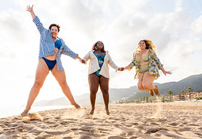 Full length of family standing at beach