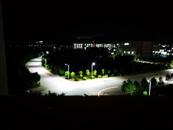 High angle view of illuminated buildings in city at night