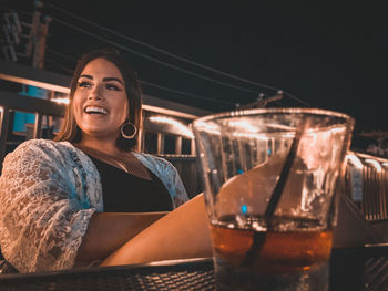 Portrait of woman drinking whiskey