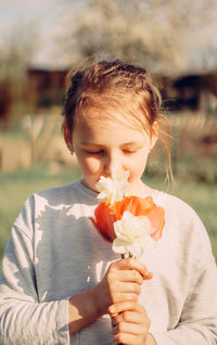 Girl holding flower head