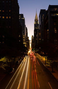 Light trails on road in city at night